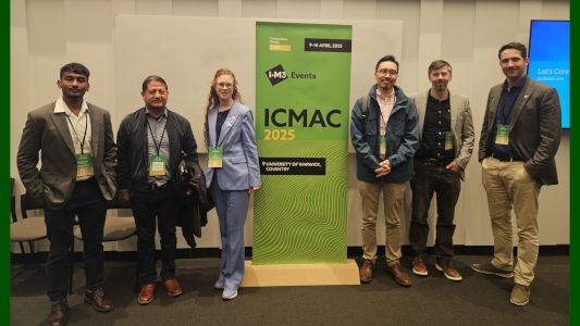 Photograph of Laura Pickard and Nic Darras and other attendees of ICMAC 2025